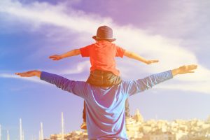 Image of a man enjoying his son with no fear of showing his positive emotions ! A strength no a weakness !